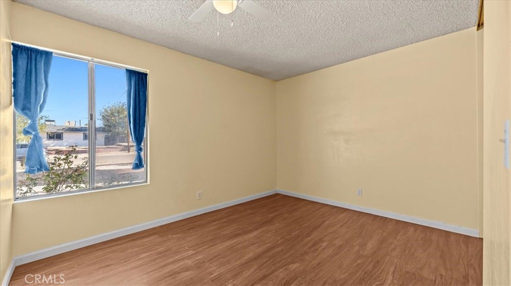 25607 Ash Road Barstow, CA 92311 - Photo 16 of 36 a view of a room with wooden floor and doors