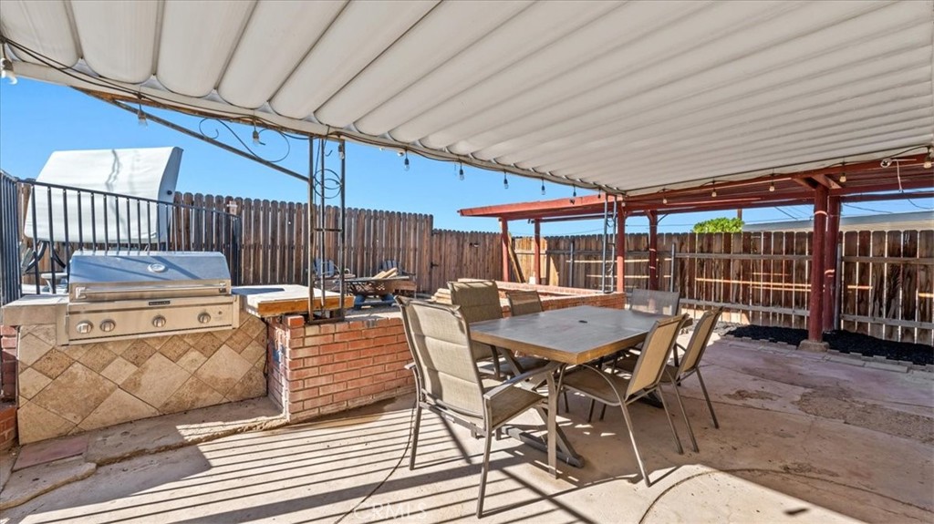 25607 Ash Road Barstow, CA 92311 - Photo 19 of 36 a view of a dinning table and chairs in the patio