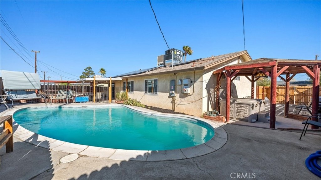 25607 Ash Road Barstow, CA 92311 - Photo 24 of 36 a view of a swimming pool with a patio
