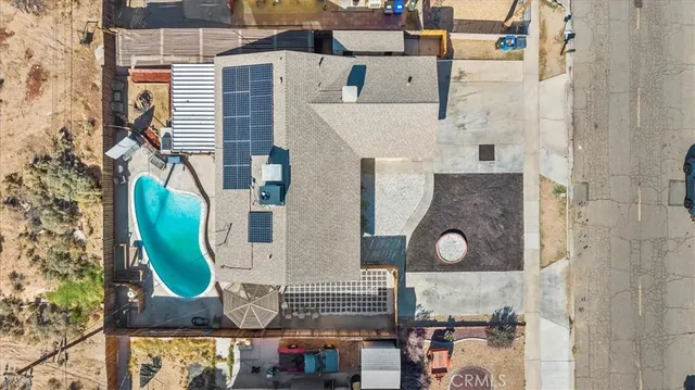 an aerial view of residential house with outdoor space and parking