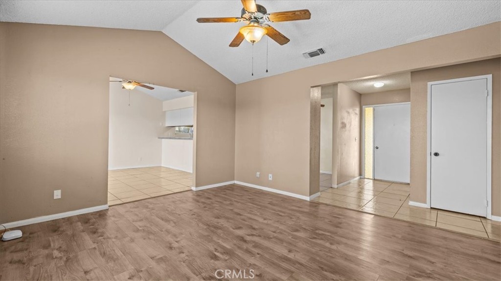 25607 Ash Road Barstow, CA 92311 - Photo 6 of 36 wooden floor in an empty room with a chandelier fan
