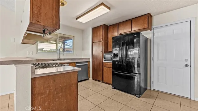 a kitchen with stainless steel appliances granite countertop a refrigerator and a stove