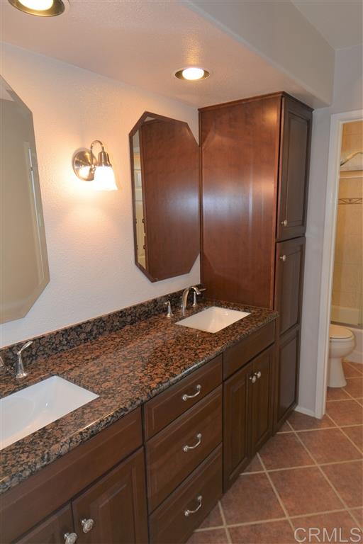 5050 Frazee Road Oceanside, CA 92057 - Photo 16 of 25 Both guest bedrooms number one and number two have private access to this wonderful double vanity full bath with tons of storage and a private water closet and combination tub shower.
