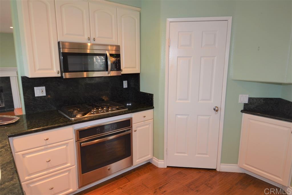 5050 Frazee Road Oceanside, CA 92057 - Photo 5 of 25 Elegantly remodeled we find the Gourmet Kitchen with new GE Profile appliances, stunning Granite Counter tops... and behind the six panel door... a walk in Pantry of dreams.