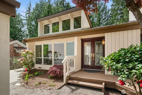 a view of backyard with deck and outdoor seating
