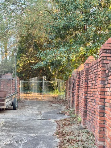 a backyard of a house with fire pit and outdoor seating