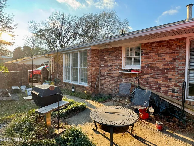 a living room with furniture a piano and a window