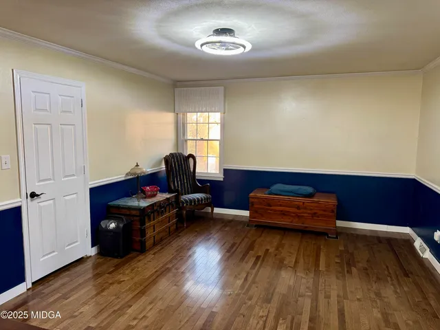 a room with wooden floors and furniture