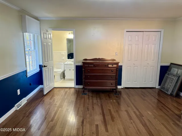 a bathroom with a granite countertop toilet a sink and a mirror