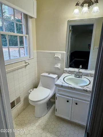a bathroom with a granite countertop sink a shower and a mirror