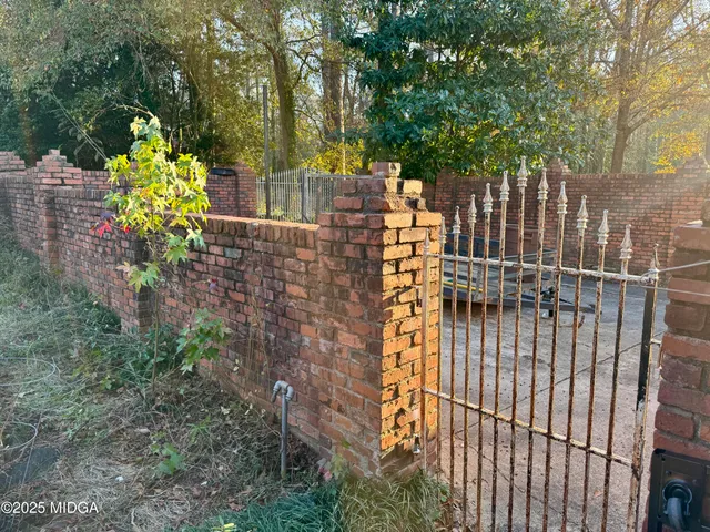 a view of a room with a large window and wooden floor