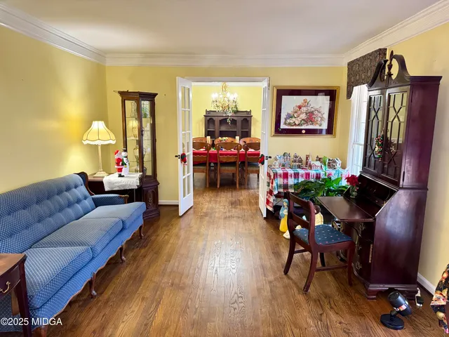 a view of a dining room with furniture and chandelier