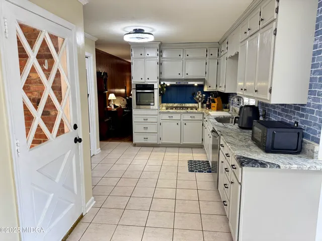 a kitchen with a stove a sink and a refrigerator