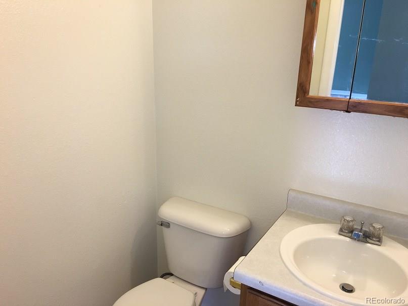 2153 Preuss Road Colorado Springs, CO 80910 - Photo 6 of 17 a white toilet sitting next to a bathroom sink