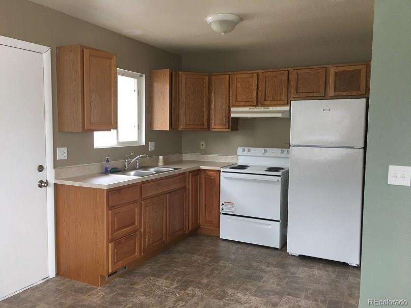2153 Preuss Road Colorado Springs, CO 80910 - Photo 9 of 17 a kitchen with a white stove top oven and refrigerator
