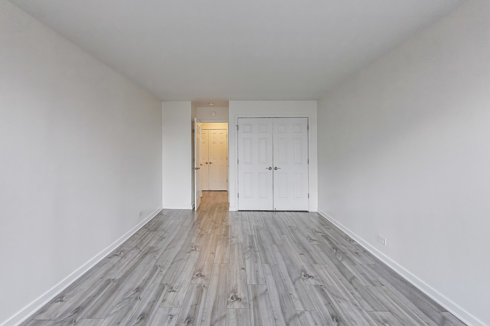 655 West Irving Park Road, Unit 606 Chicago, IL 60613 - Photo 18 of 29 a view of an empty room and wooden floor