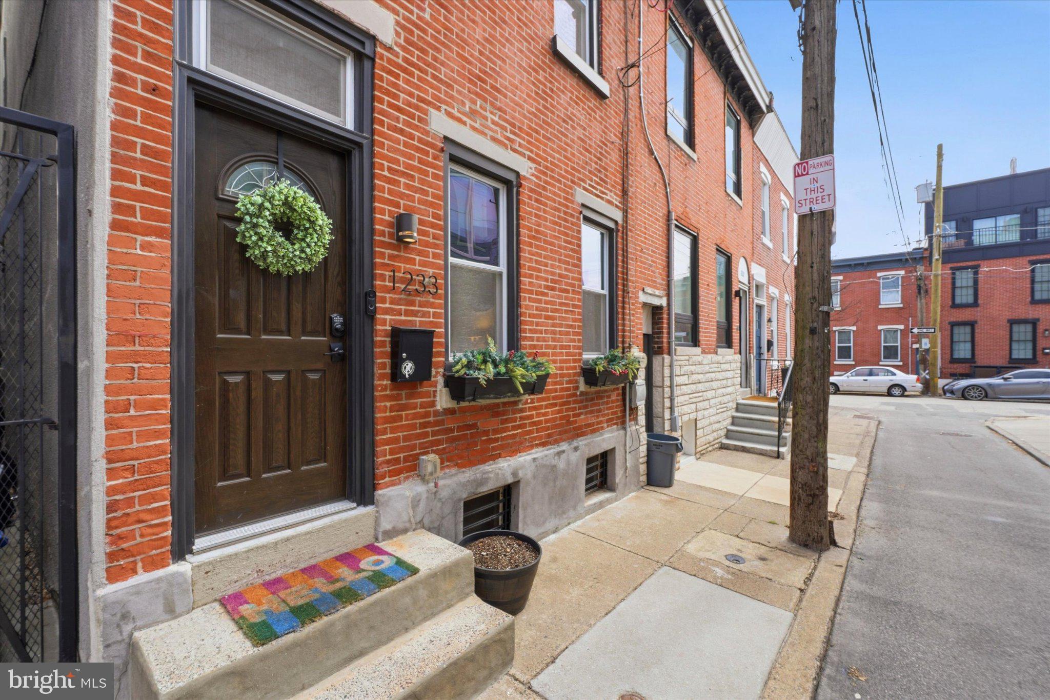 1233 East Colona Street Philadelphia, PA 19125 - Photo 2 of 25 Charming brick facade with vibrant entryway.