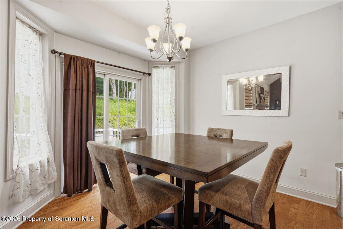 99 Hilltop Road Waverly, PA 18471 - Photo 12 of 41 a view of a dining room with furniture window and wooden floor