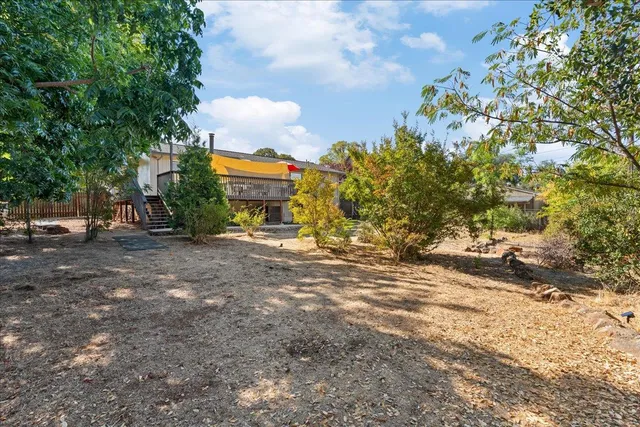 a backyard of a house with shaded area