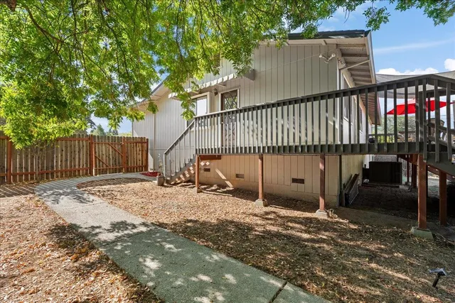 a view of a wooden house with a bench in the patio