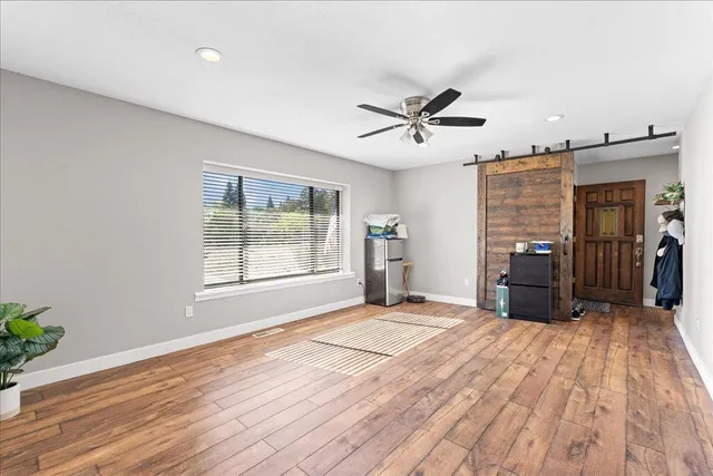 a bedroom with a bed and a ceiling fan