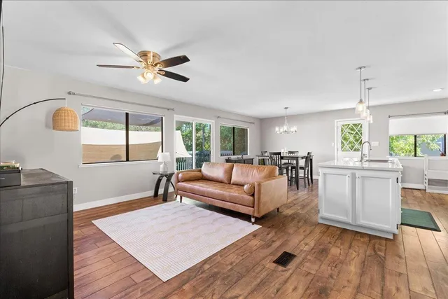 a living room with furniture and wooden floor