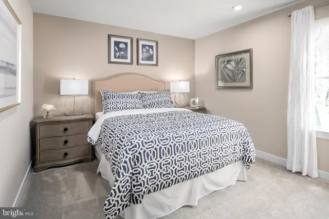 a bedroom with a bed and painting on the wall