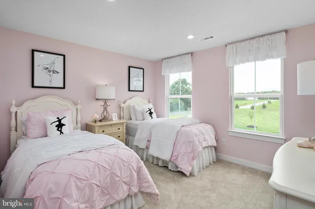 a spacious bedroom with two bed and a window