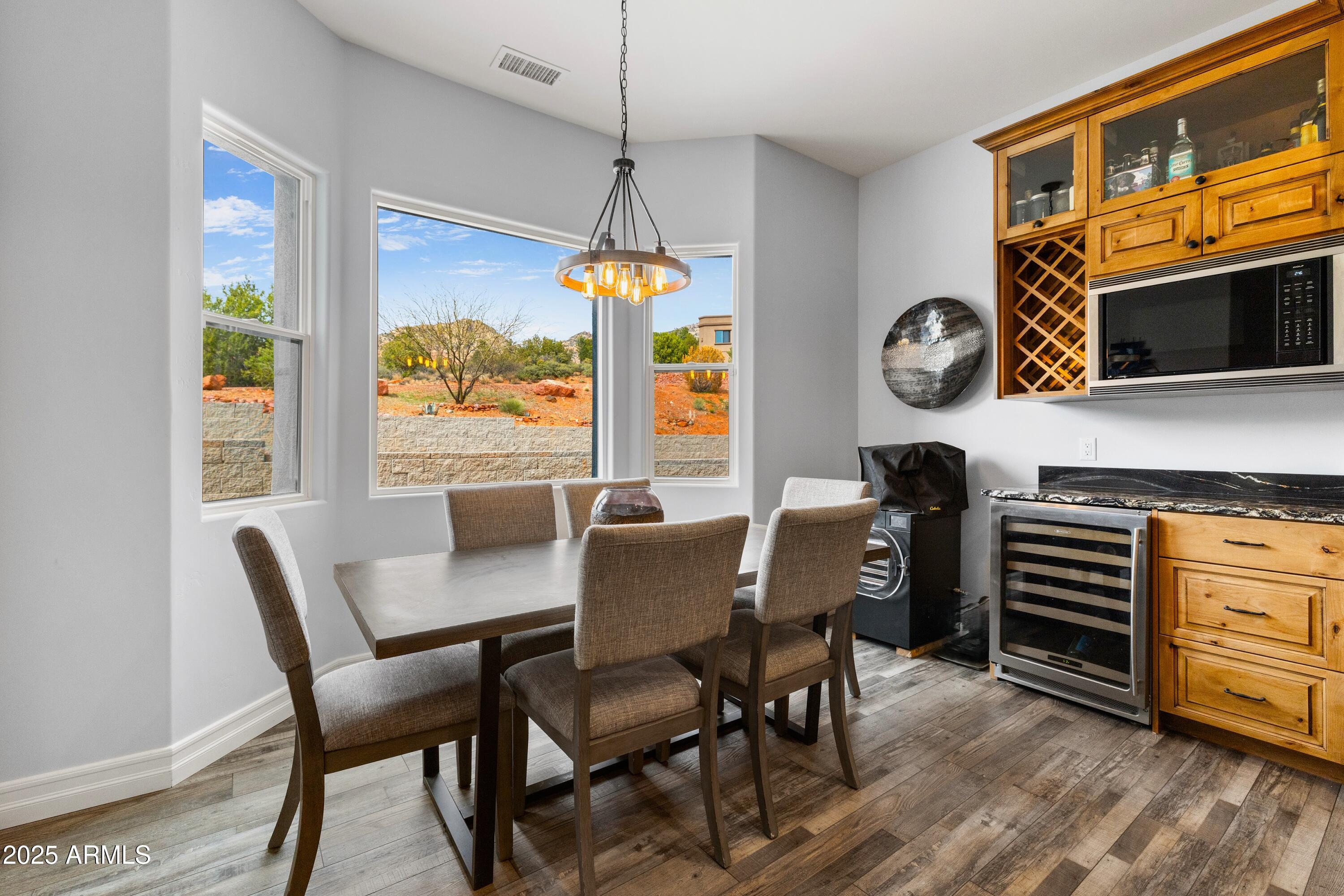 10 Ho Hum Circle Sedona, AZ 86351 - Photo 20 of 48 a dining room with furniture a flat screen tv and a window