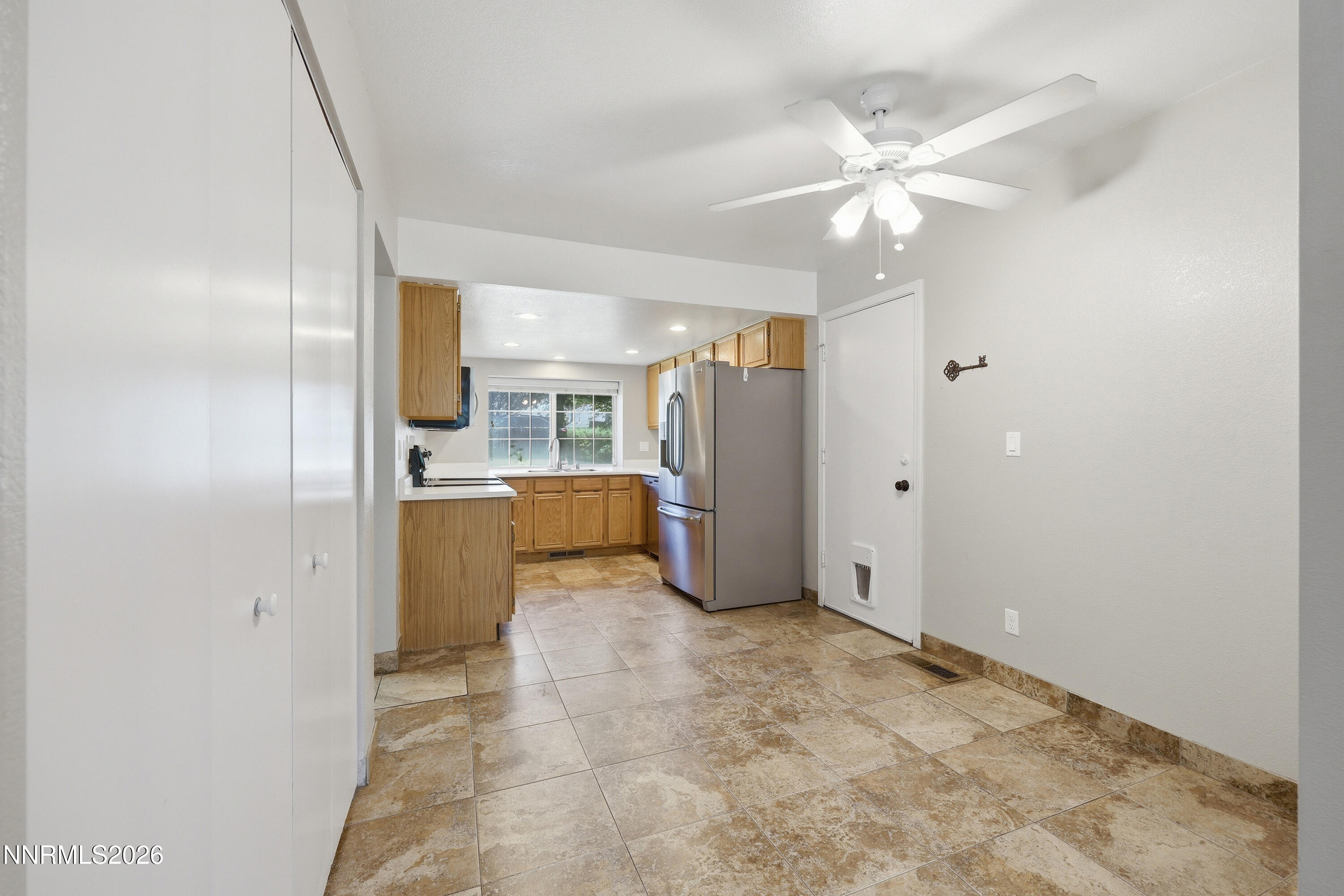 1899 Tuolumne Drive Reno, NV 89523 - Photo 11 of 44 a view of a kitchen with refrigerator and cabinets