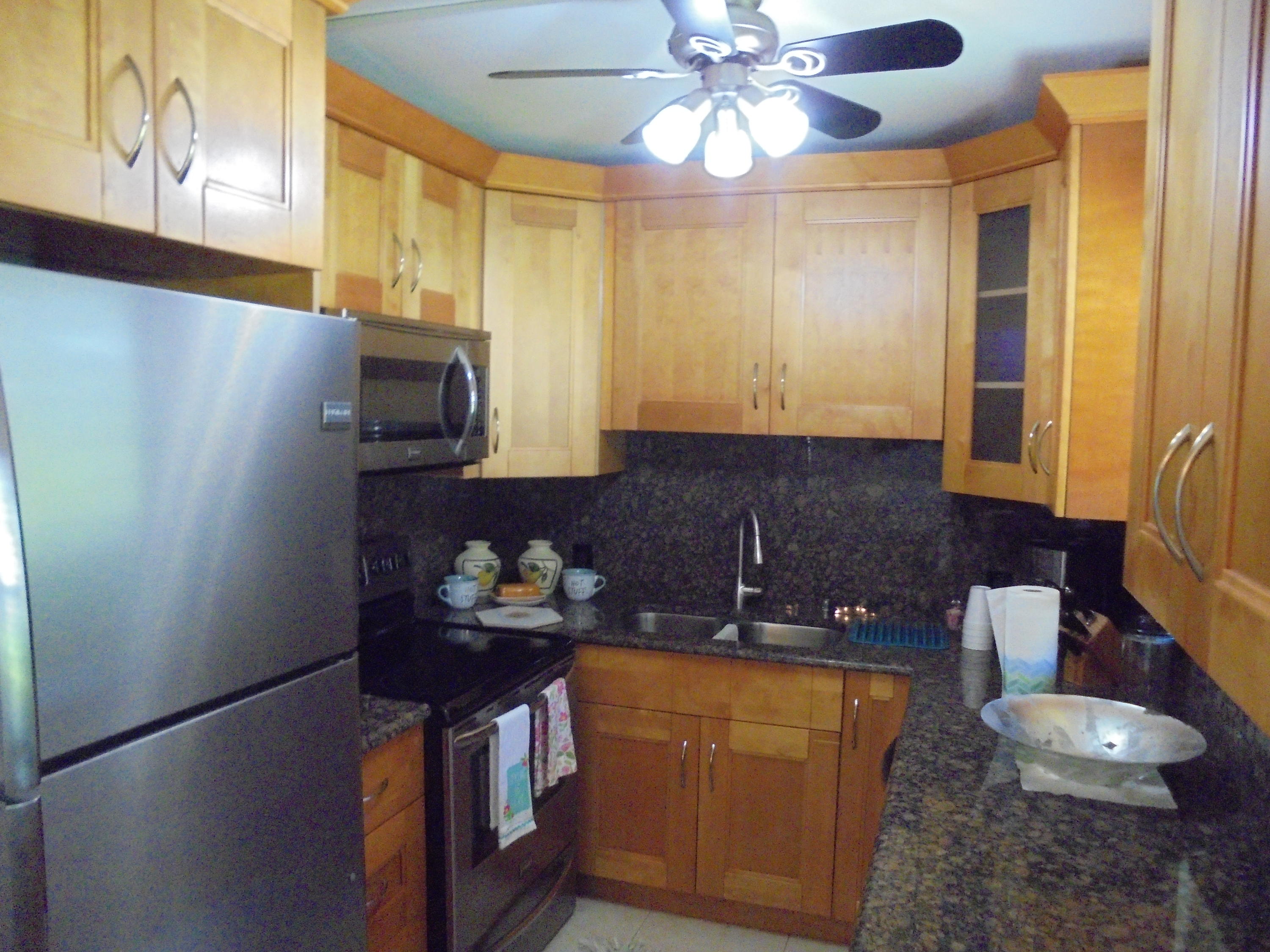 14 Brighton A Boca Raton, FL 33434 - Photo 2 of 15 a kitchen with stainless steel appliances granite countertop a refrigerator a stove and a sink