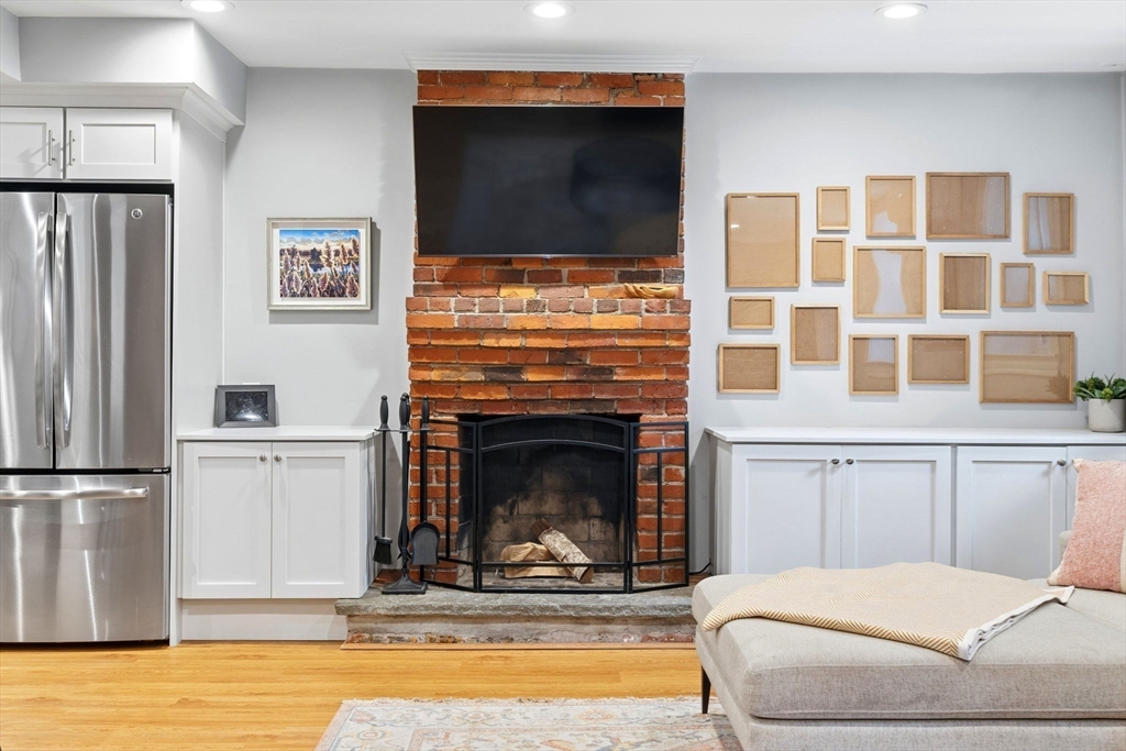 35 High Street, Unit 1 Boston, MA 02129 - Photo 20 of 33 a living room with a fireplace and a flat screen tv