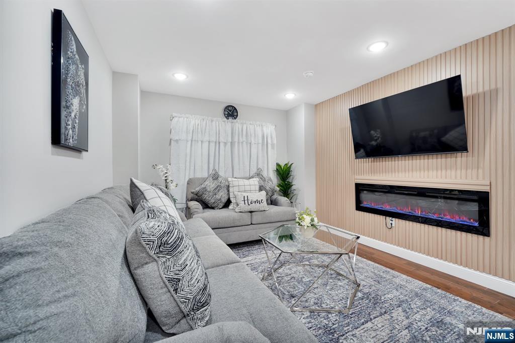 225 South 9th Street Newark, NJ 07103 - Photo 11 of 35 a living room with furniture and a flat screen tv
