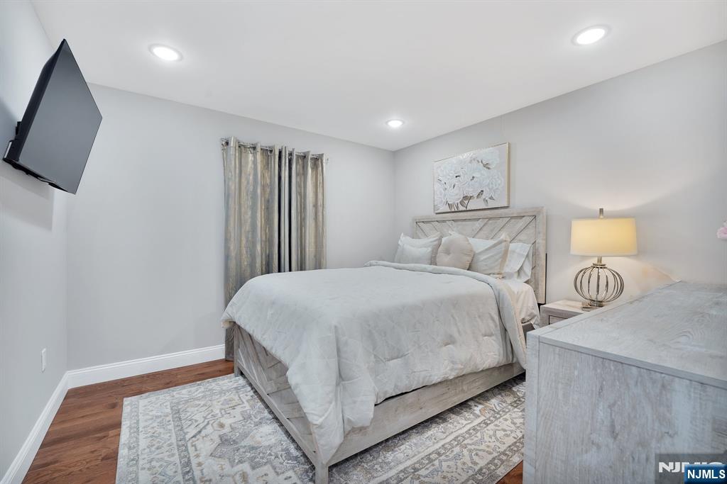 225 South 9th Street Newark, NJ 07103 - Photo 12 of 35 a bedroom with a bed and a flat screen tv