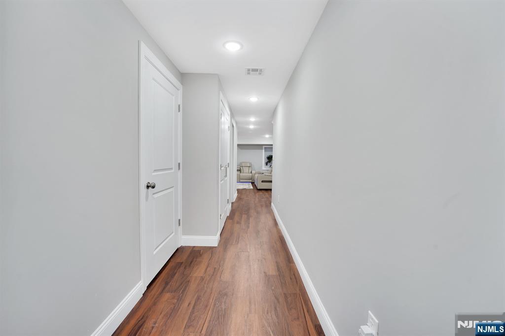 225 South 9th Street Newark, NJ 07103 - Photo 15 of 35 a view of a hallway with wooden floor and staircase
