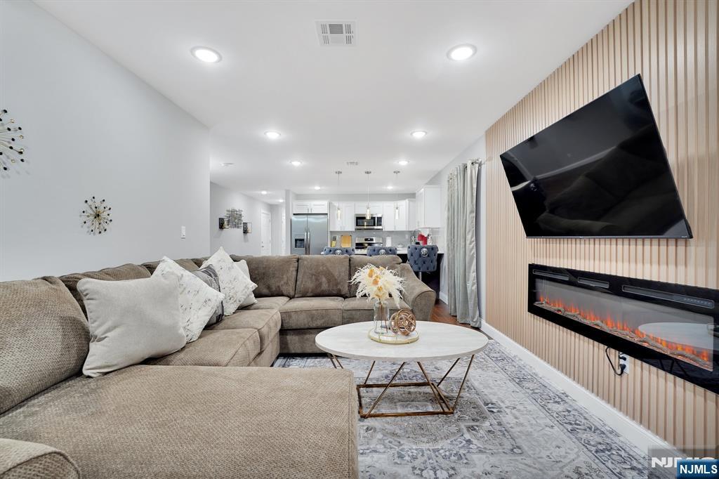 225 South 9th Street Newark, NJ 07103 - Photo 23 of 35 a living room with furniture and a flat screen tv