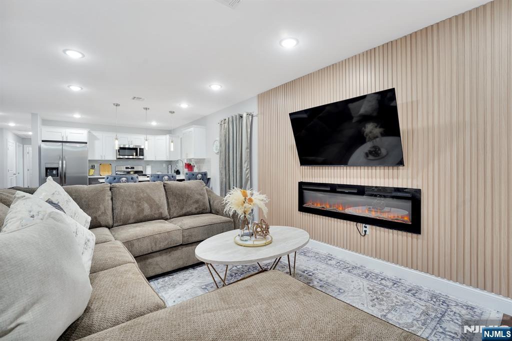 225 South 9th Street Newark, NJ 07103 - Photo 24 of 35 a living room with furniture and a flat screen tv