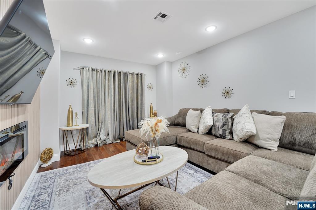 225 South 9th Street Newark, NJ 07103 - Photo 25 of 35 a living room with furniture and wooden floor