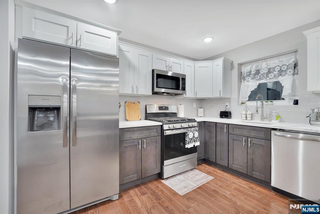 225 South 9th Street Newark, NJ 07103 - Photo 8 of 35 a kitchen with a refrigerator sink and microwave