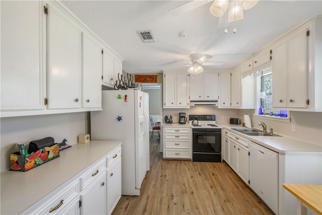 3675 Zulch Road North Zulch, TX 77872 - Photo 12 of 22 a kitchen with a white cabinets and white appliances