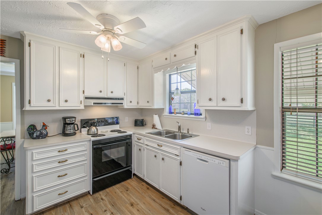 3675 Zulch Road North Zulch, TX 77872 - Photo 13 of 22 a kitchen with cabinets appliances a sink and a window