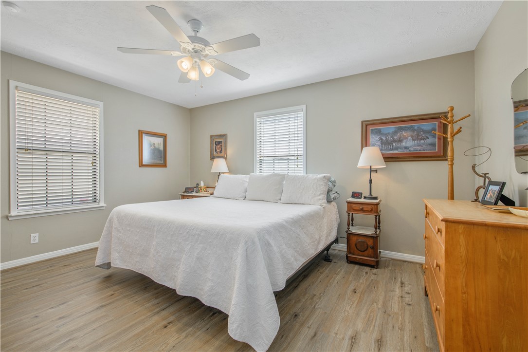 3675 Zulch Road North Zulch, TX 77872 - Photo 15 of 22 a bedroom with a bed and a chandelier