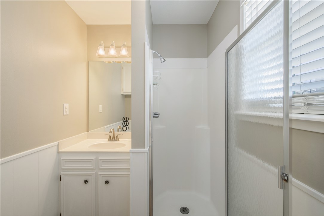 3675 Zulch Road North Zulch, TX 77872 - Photo 16 of 22 a bathroom with a shower sink and mirror