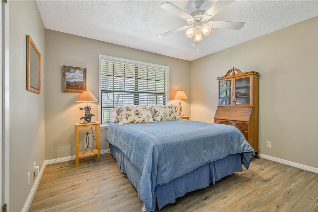 3675 Zulch Road North Zulch, TX 77872 - Photo 17 of 22 a bedroom with a bed and a chandelier