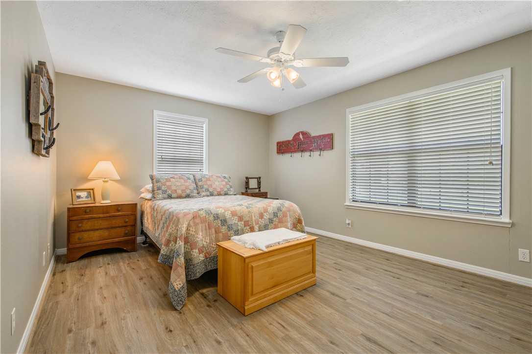 3675 Zulch Road North Zulch, TX 77872 - Photo 18 of 22 a spacious bedroom with a bed and a chandelier