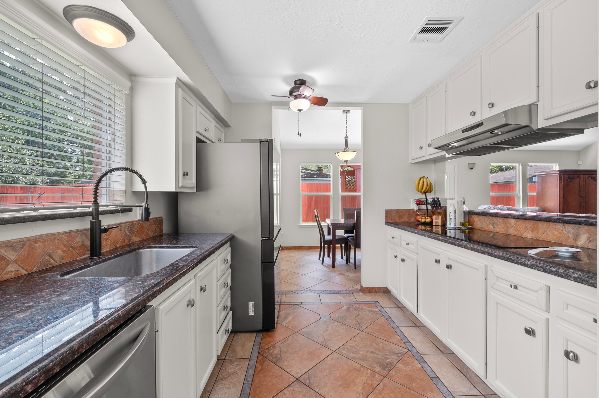 706 Geronimo Court Katy, TX 77450 - Photo 12 of 29 a kitchen with granite countertop a sink stainless steel appliances and cabinets