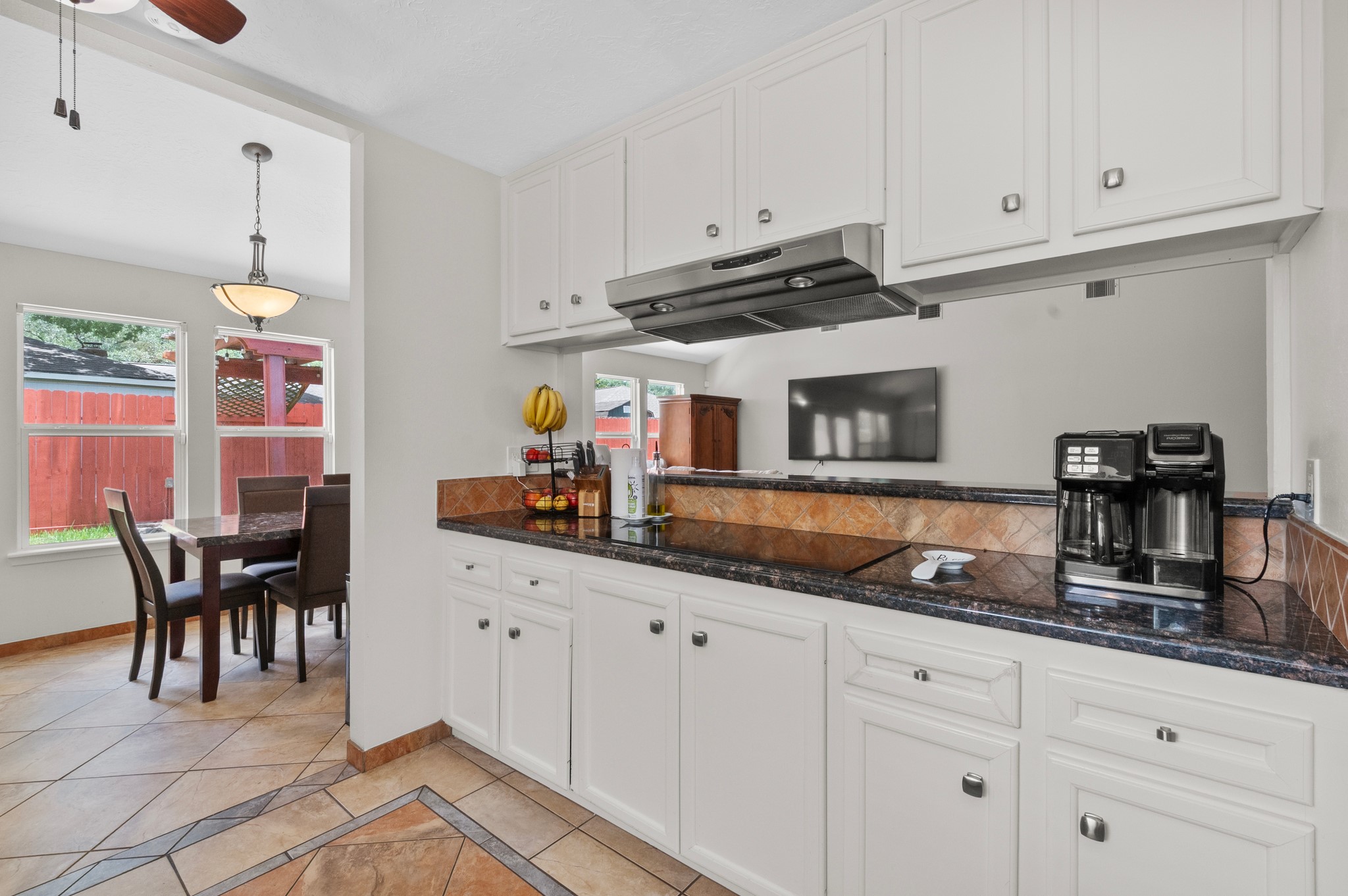 706 Geronimo Court Katy, TX 77450 - Photo 13 of 29 a kitchen with granite countertop white cabinets and white appliances