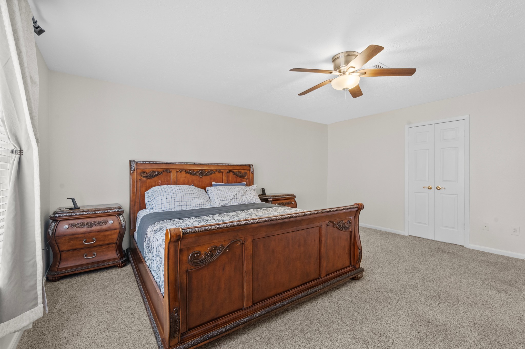 706 Geronimo Court Katy, TX 77450 - Photo 15 of 29 a bedroom with a bed and a chandelier