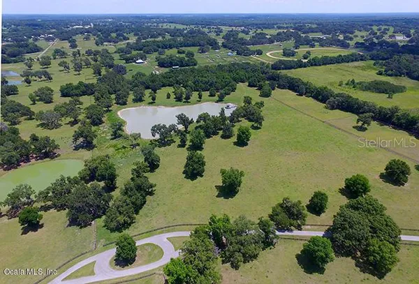 an aerial view of a houses with a lake