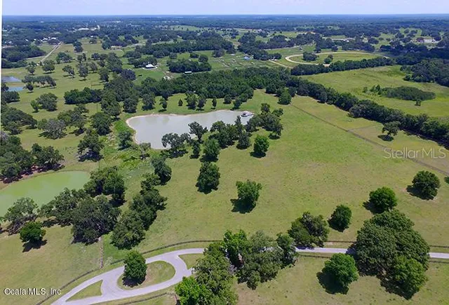 an aerial view of a houses with a lake